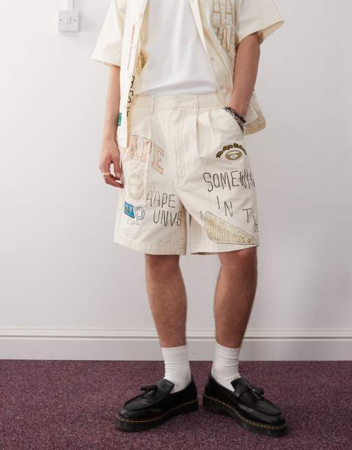 Aape by A Bathing Ape multi logo college shorts in beige