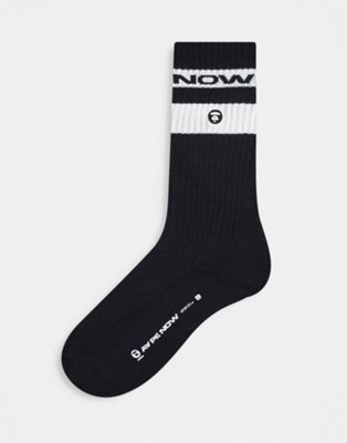 Aape by A Bathing Ape now socks in black with white sport stripes and logo print