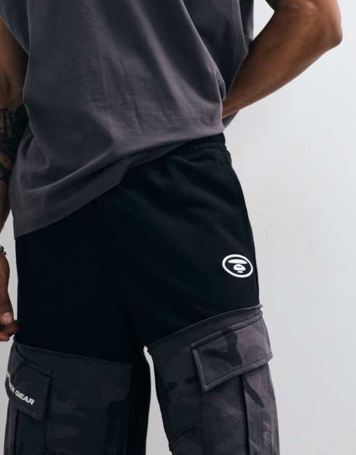 Aape by A Bathing Ape - Pantaloncini neri in jersey ampi con tasche mimetiche, 5 di 5