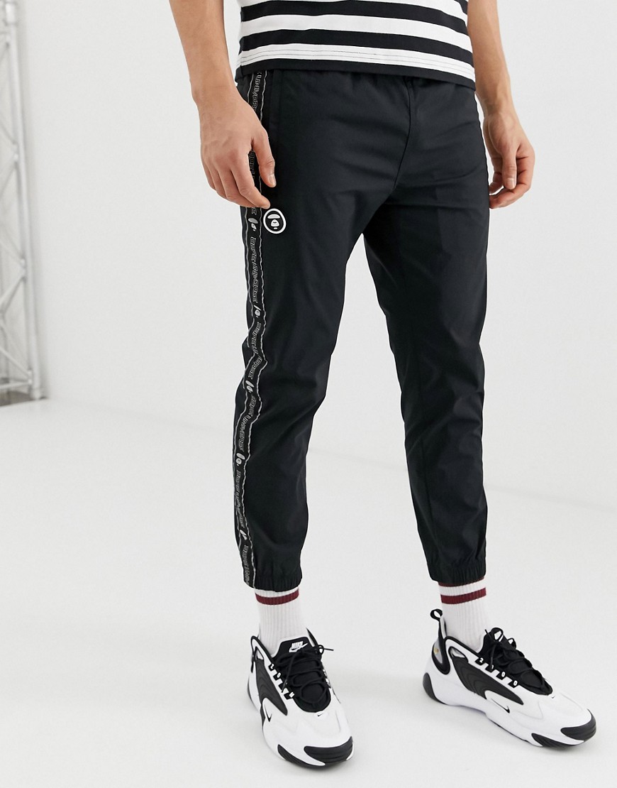 AAPE By A Bathing Ape track joggers with logo taping in black