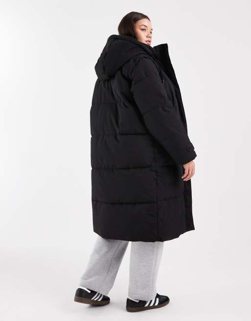 Abrigo largo negro acolchado con diseño en y mangas extraíbles