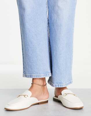 Accessorize backless loafers with snaffle in white