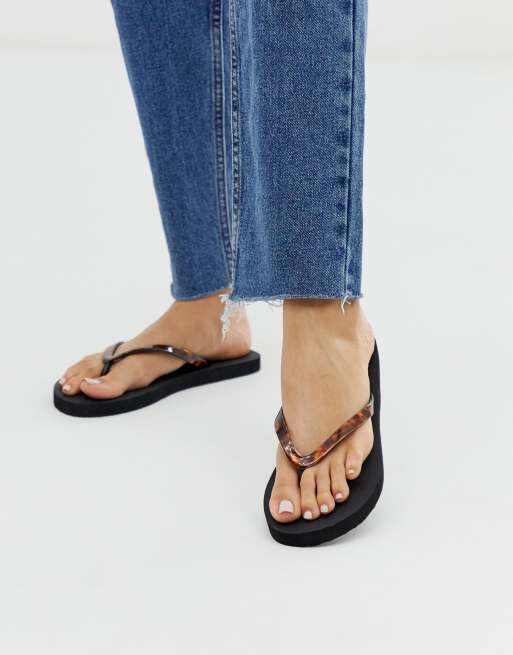 Accessorize black flip flops with tortoise effect straps ASOS