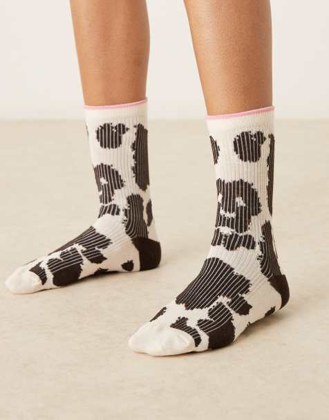 Accessorize cow print socks in black and white - view 1