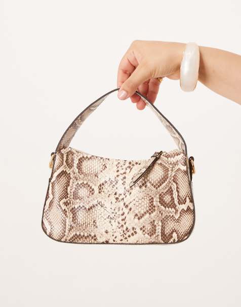 Accessorize curved handheld snake bag in beige - view 1