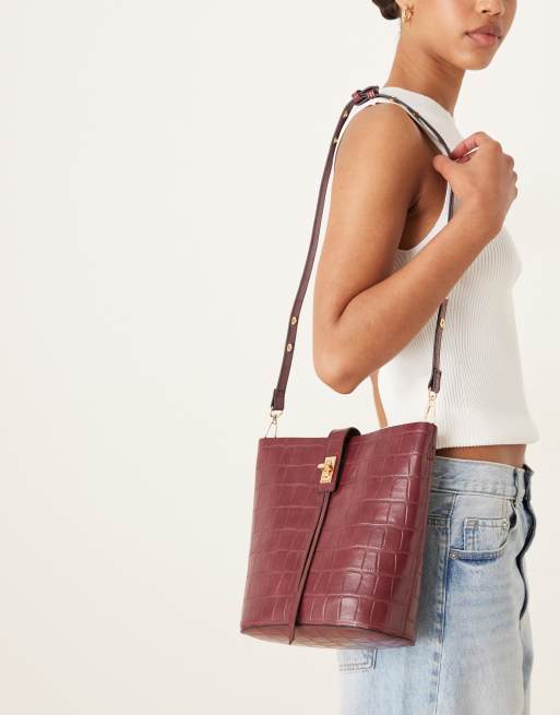 Accessorize faux croc bucket bag in burgundy | ASOS
