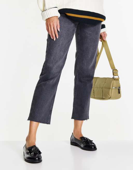 Accessorize flat loafers with tassels in black patent