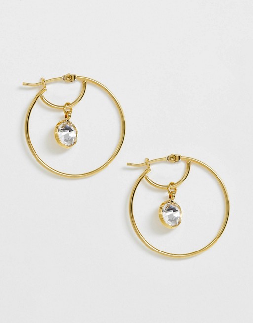 Accessorize gold hoop earrings with Swarovski stone