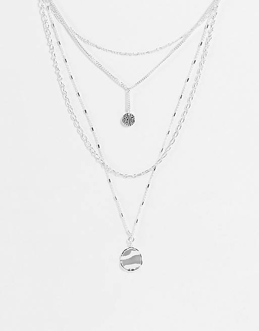 Accessorize layering necklaces in silver