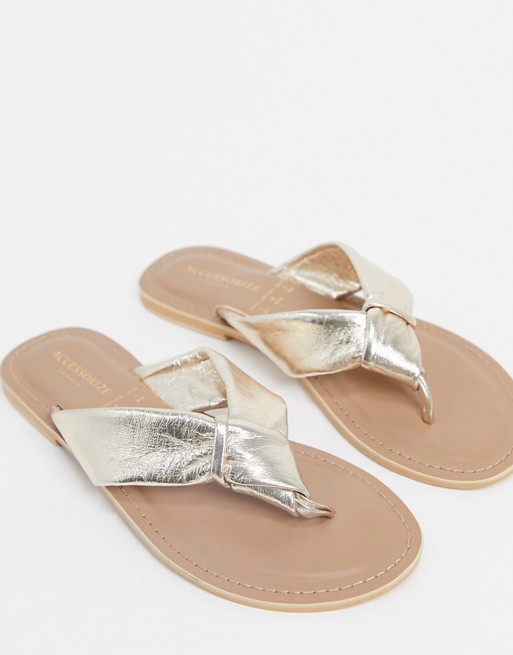 Accessorize leather knotted flip flops in rose gold