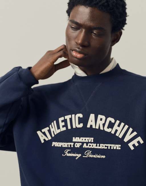 A.Collective heavyweight crew neck sweater with chest print in navy, 2 of 9
