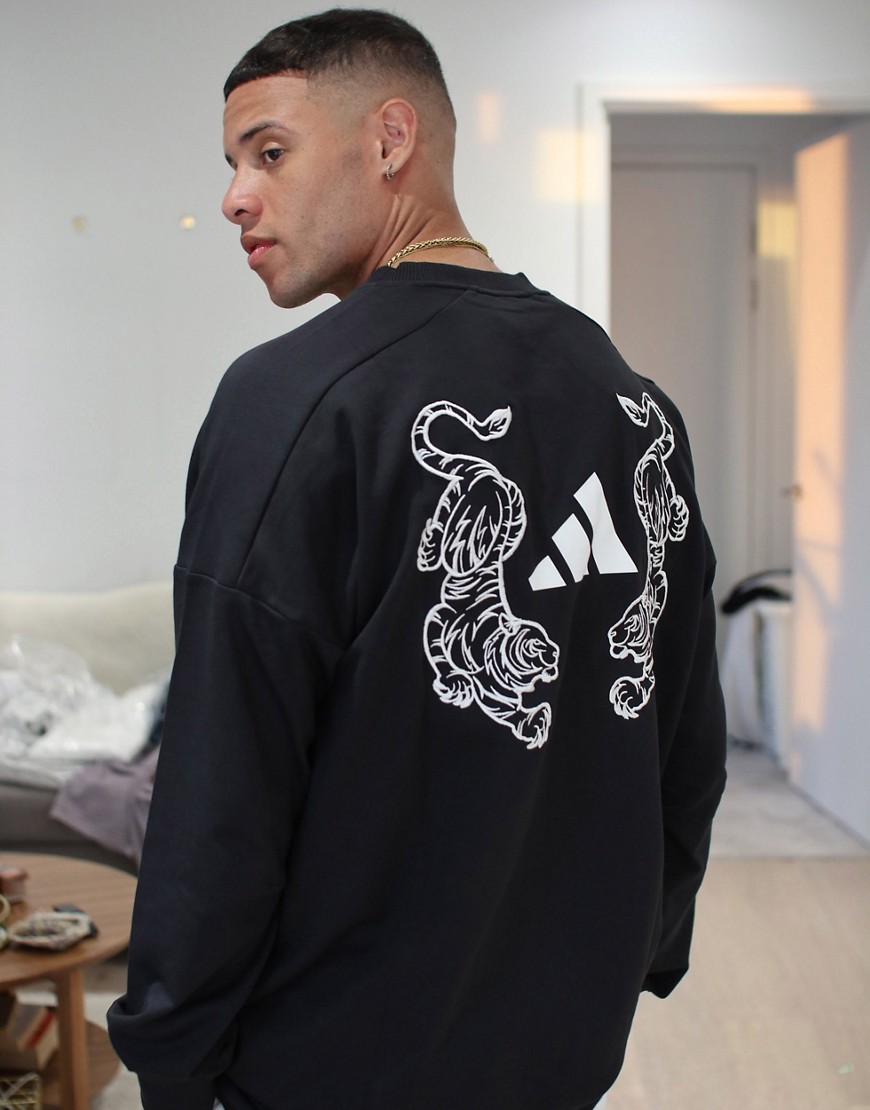 adidas 3 - Gestreepte sweater met tijgerprint op de achterkant in zwart