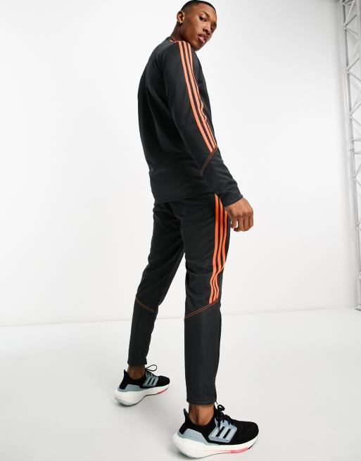 Black adidas pants discount with orange stripes