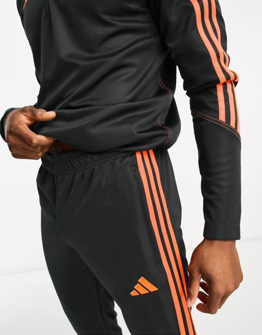 Black adidas hot sale tracksuit orange stripes