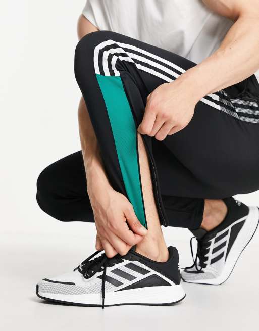 Adidas hose schwarz store grüne streifen