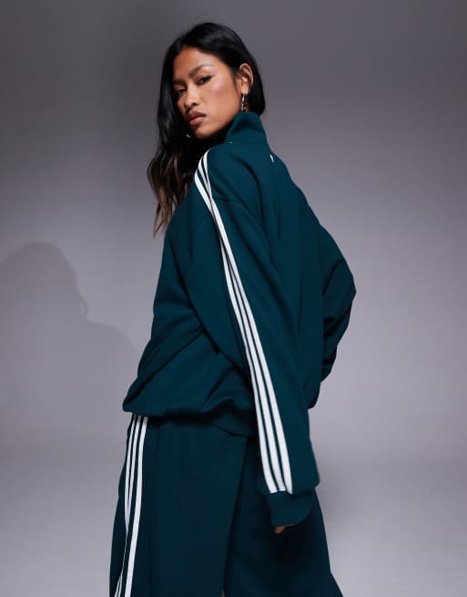 adidas Originals 1/4 zip sweatshirt in green with front graphic | ASOS