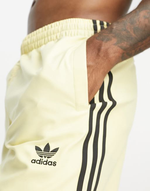 adidas Originals 3 Stripe swim shorts in yellow