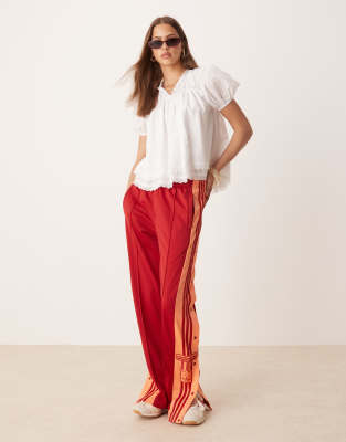 adidas Originals - Adibreak - Trainingshose in Rot und Orange