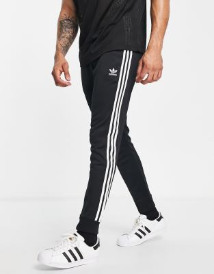 adidas originals superstar 3 stripe skinny joggers in black