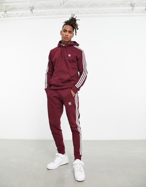 adidas Originals 3 stripe trackies in burgundy | ASOS