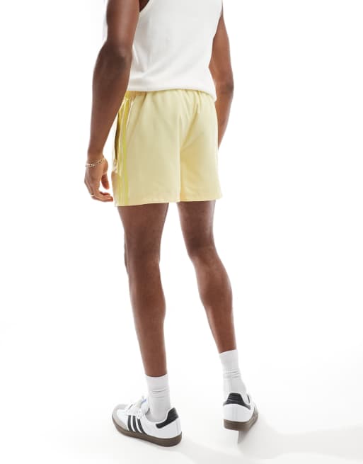 adidas Originals Adicolor 3-Stripes 5-Inch Swim Shorts in yellow