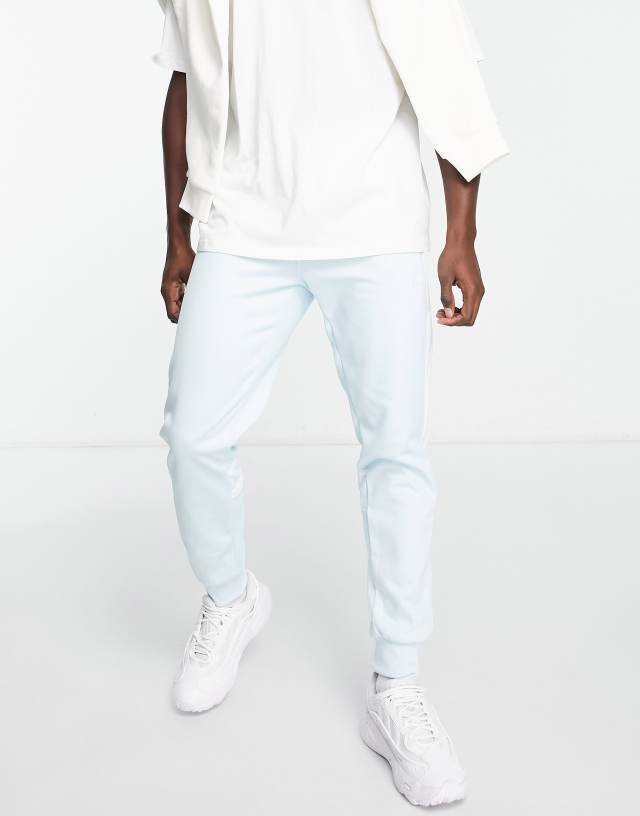 adidas Originals adicolor Challenger three stripe slim fit sweatpants in almost blue