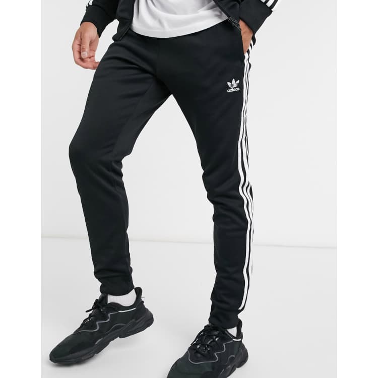 Porcentaje provocar radiador adidas Originals – adicolor – Eng geschnittene Jogginghose mit den drei  Streifen in Schwarz | ASOS