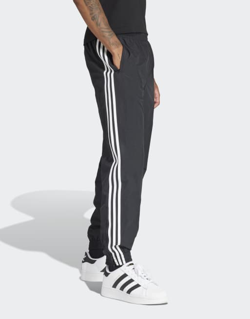 adidas Originals – Adicolor Firebird – Trainingshose aus Webstoff in Schwarz