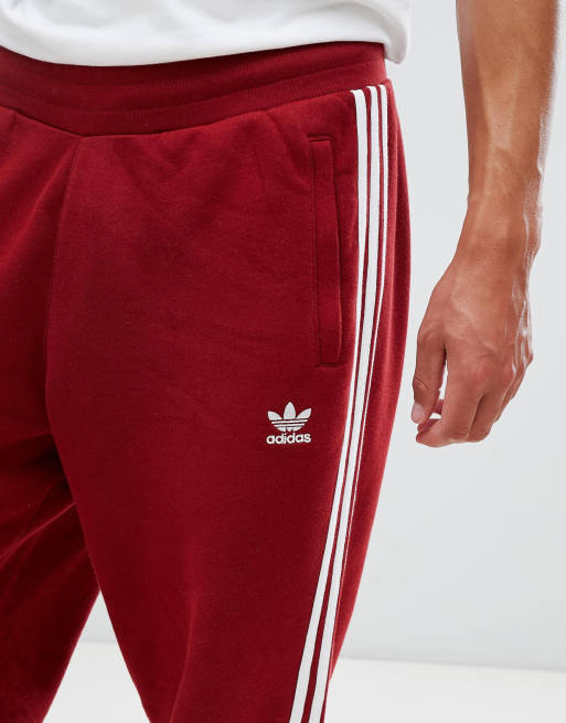 adidas Originals adicolor Joggingbroek met 3 strepen in rood CW2428