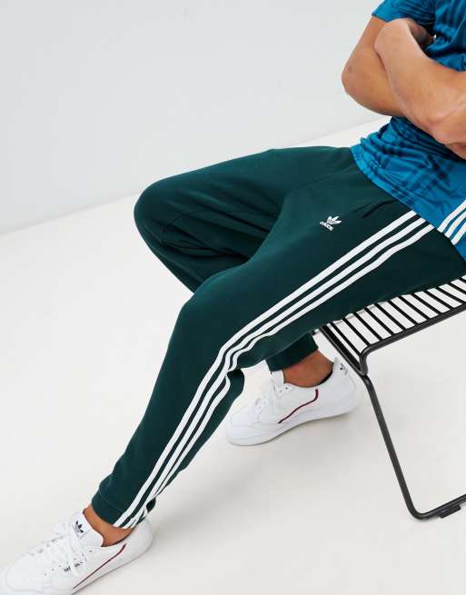 adidas Originals – Adicolor – Leggings in Dunkelgrün mit den 3 Streifen