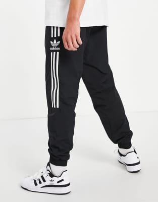 adidas originals adicolor locked up logo track pants in black