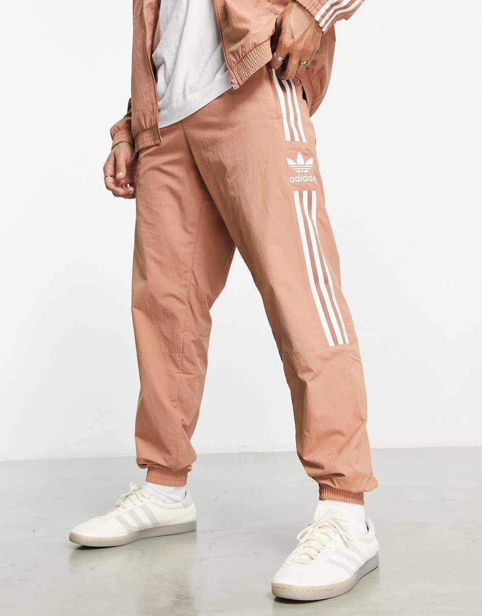 adidas Originals Adicolor lock up track joggers in orange