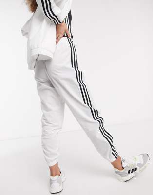 adidas originals adicolor locked up logo track pants in white