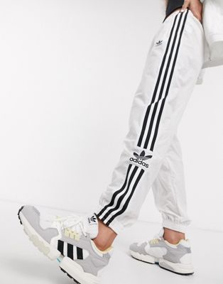 adidas originals adicolor locked up logo track pants in white