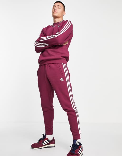 adidas Originals – adicolor – Plommonfärgade mjukisbyxor med tre ränder