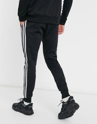adidas originals superstar 3 stripe joggers in black