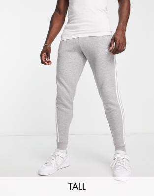 adidas Originals Adicolor Tall 3 stripe slim joggers in grey | ASOS