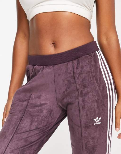 adidas Originals adicolor three stripe faux suede flared track pants in maroon