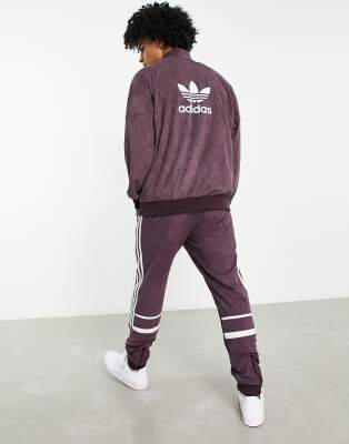 adidas Originals adicolor three stripe faux suede track jacket in maroon