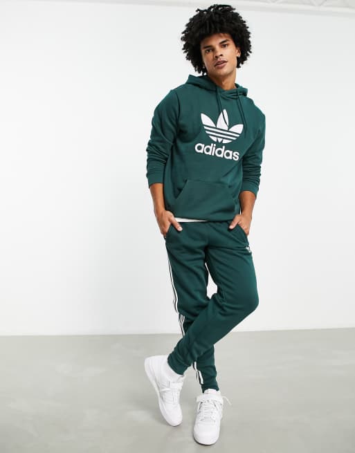 adidas Originals adicolor three stripe joggers in green