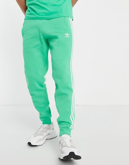 adidas Originals adicolor three stripe joggers in green ASOS