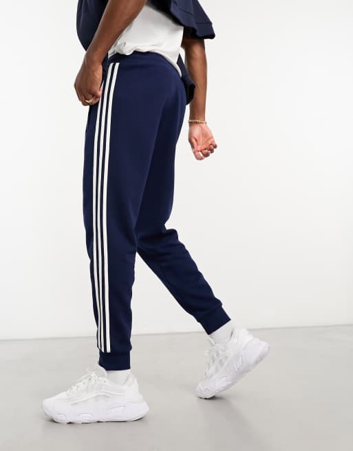 adidas Originals adicolor three stripe joggers in navy