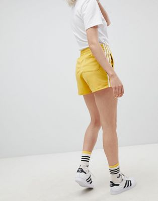 adidas originals adicolor three stripe shorts in yellow