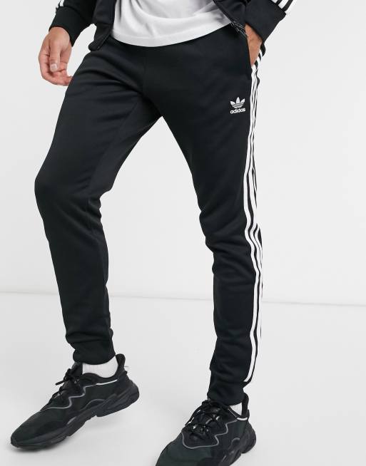 adidas Originals adicolor three stripe skinny joggers in black