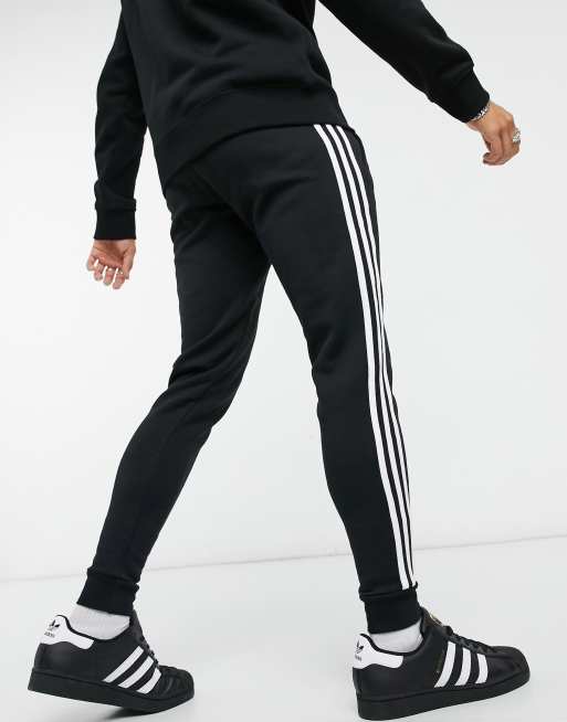 adidas Originals adicolor three stripe skinny joggers in black