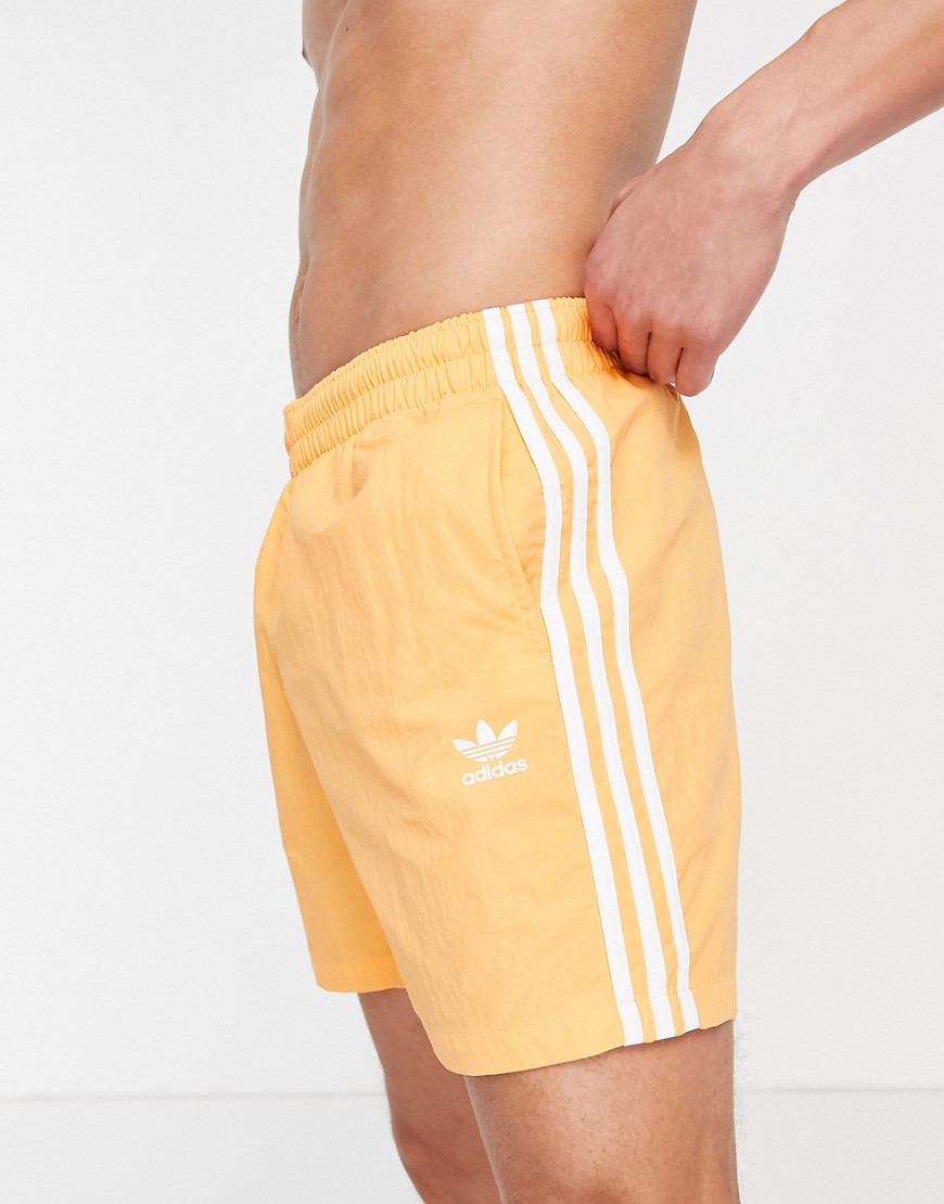 Adidas Originals adicolor three stripe swim shorts in orange