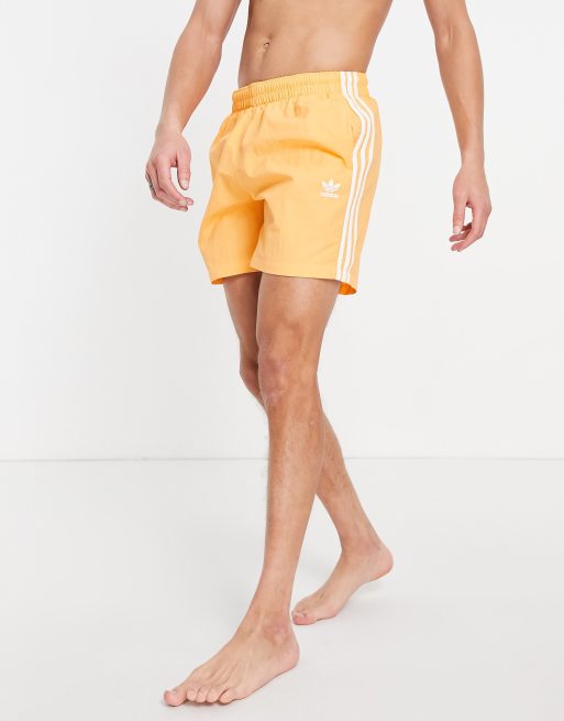 adidas Originals adicolor three stripe swim shorts in orange |