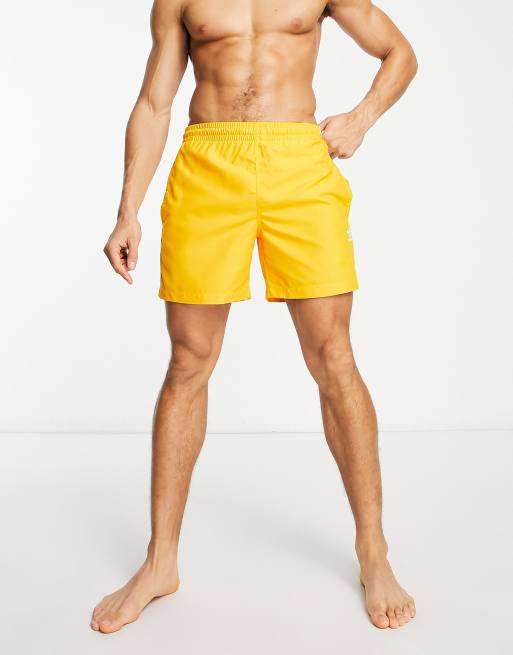 adidas Originals adicolor three stripe swim shorts in yellow