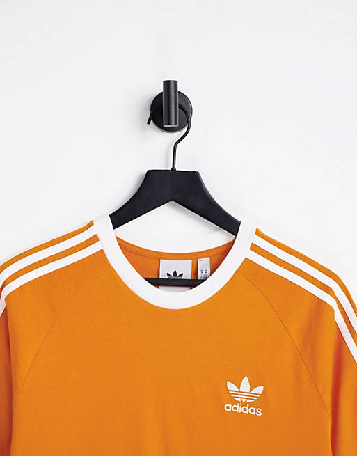 scared dictionary volleyball adidas Originals adicolor three stripe t-shirt in orange | ASOS