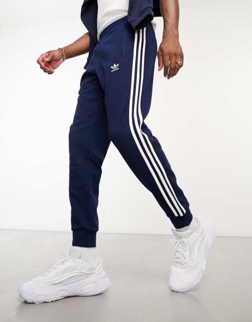 adidas Originals adicolor three stripe trackies in navy